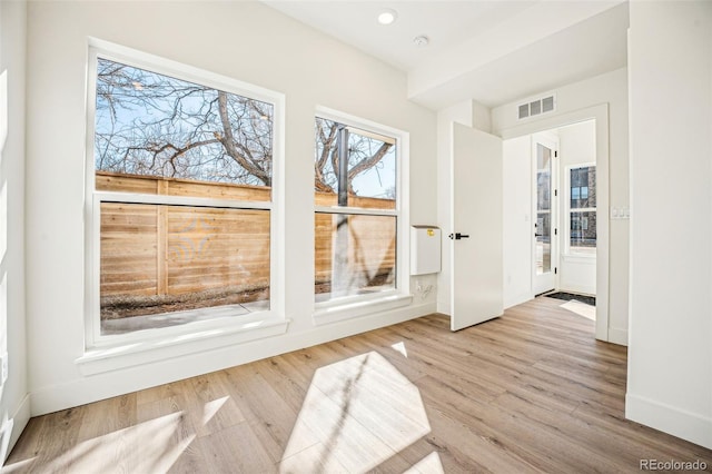 interior space featuring baseboards, visible vents, wood finished floors, and recessed lighting