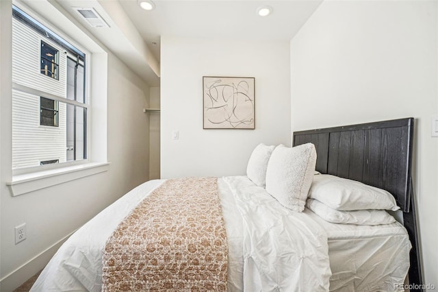 bedroom with recessed lighting, visible vents, and baseboards