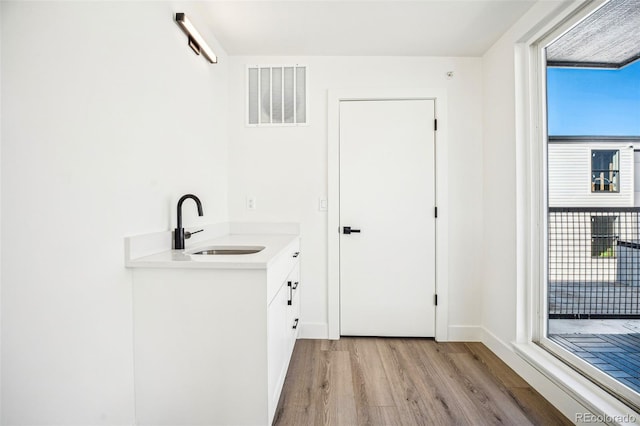 bathroom featuring visible vents, wood finished floors, and vanity