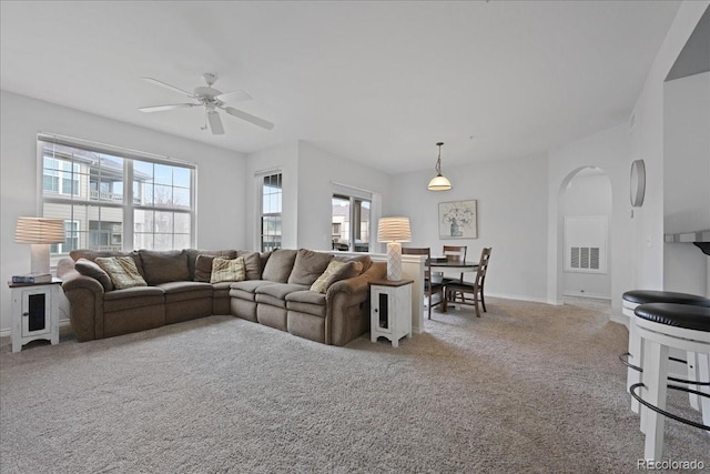 living room featuring light colored carpet and ceiling fan