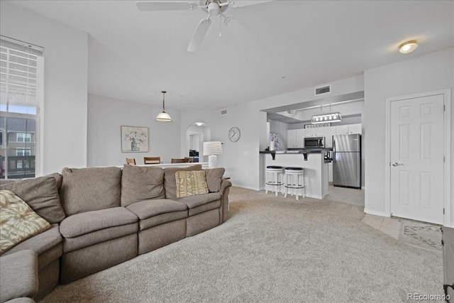 carpeted living room featuring ceiling fan