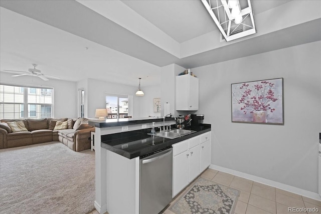 kitchen featuring white cabinetry, stainless steel dishwasher, kitchen peninsula, and sink