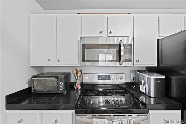 kitchen with stainless steel appliances and white cabinets