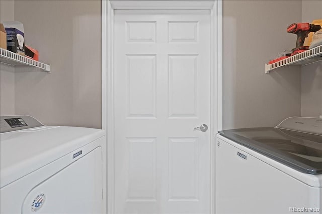 clothes washing area featuring washer and clothes dryer