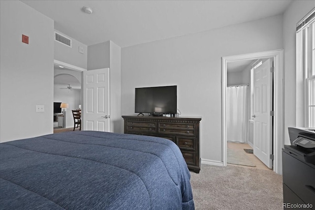 bedroom featuring light carpet