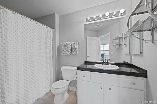 bathroom featuring vanity, tile patterned floors, and toilet