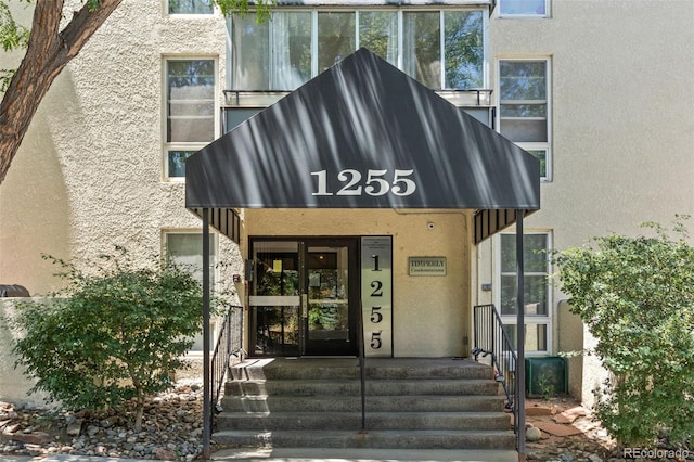 1255 N Ogden St Unit 406, Denver, CO 80218 - doorway to property with stucco siding