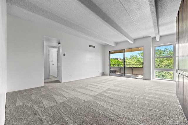 1255 N Ogden St Unit 406, Denver, CO 80218 - empty room featuring carpet flooring, a textured ceiling, and beamed ceiling