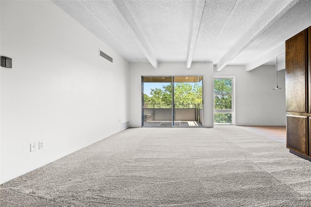 1255 N Ogden St Unit 406, Denver, CO 80218 - unfurnished room featuring a textured ceiling, beamed ceiling, and carpet floors