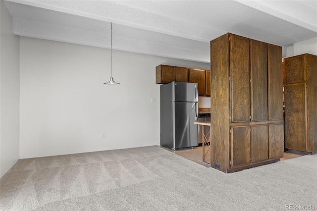 1255 N Ogden St Unit 406, Denver, CO 80218 - kitchen with appliances with stainless steel finishes, light carpet, and a textured ceiling