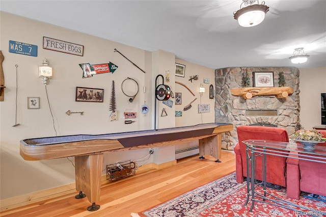 31112 Shadow Mountain Dr, Conifer, CO 80433 - rec room featuring wood finished floors and baseboard heating