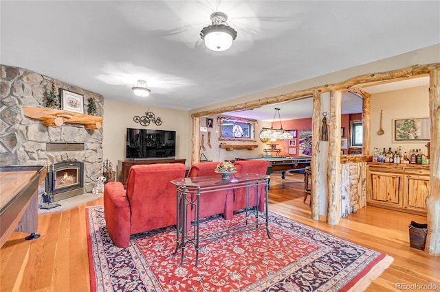 31112 Shadow Mountain Dr, Conifer, CO 80433 - living room featuring billiards table, wood finished floors, and a stone fireplace