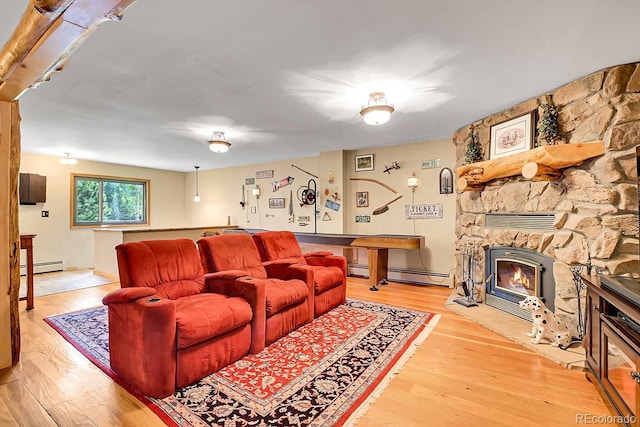 31112 Shadow Mountain Dr, Conifer, CO 80433 - living area featuring baseboard heating, wood finished floors, and a stone fireplace
