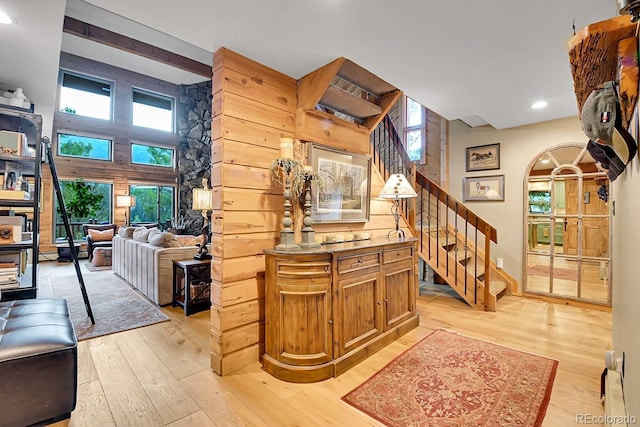 31112 Shadow Mountain Dr, Conifer, CO 80433 - stairway featuring wood-type flooring, arched walkways, and recessed lighting
