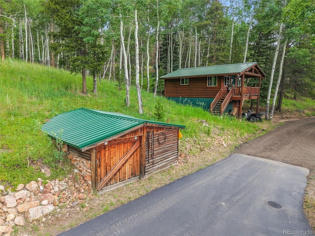 31112 Shadow Mountain Dr, Conifer, CO 80433 - view of front of home featuring a metal roof, stairway, and a forest view