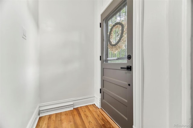 doorway to outside with hardwood / wood-style flooring and a wealth of natural light