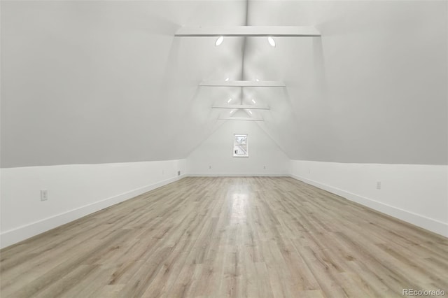 bonus room featuring vaulted ceiling and light hardwood / wood-style flooring