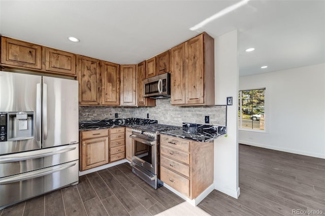kitchen with brown cabinetry, decorative backsplash, dark wood-style floors, recessed lighting, and appliances with stainless steel finishes
