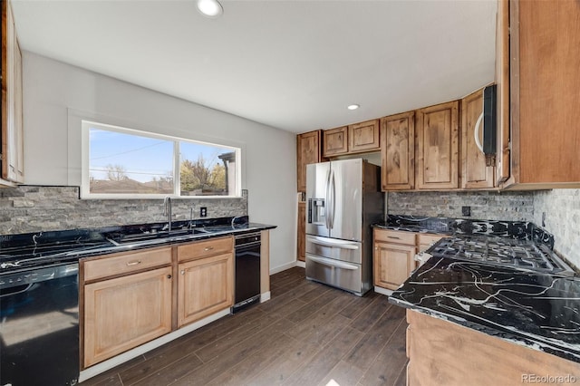 kitchen featuring dishwasher, stainless steel fridge, a sink, dark wood finished floors, and backsplash