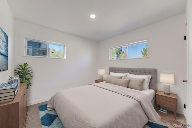 bedroom with recessed lighting, baseboards, and light colored carpet