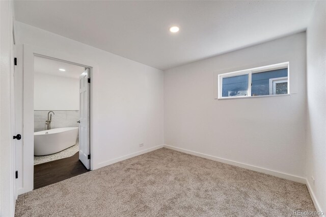 unfurnished bedroom featuring baseboards, carpet flooring, and recessed lighting