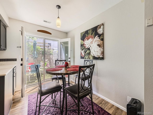 4121 W 111th Cir, Westminster, CO 80031 - dining space featuring light wood finished floors and a textured wall