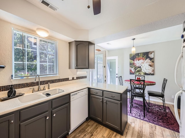 4121 W 111th Cir, Westminster, CO 80031 - kitchen with white appliances, light wood-style flooring, a peninsula, light countertops, and a ceiling fan