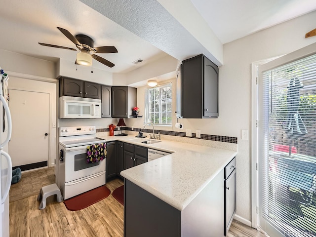 4121 W 111th Cir, Westminster, CO 80031 - kitchen featuring white appliances, a peninsula, light wood-style flooring, and ceiling fan