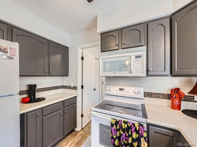 4121 W 111th Cir, Westminster, CO 80031 - kitchen featuring white appliances, light wood-style floors, and gray cabinetry