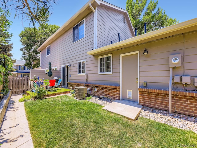 4121 W 111th Cir, Westminster, CO 80031 - rear view of house with brick siding and a patio