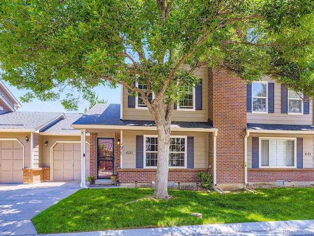 4121 W 111th Cir, Westminster, CO 80031 - view of front of house featuring an attached garage, driveway, brick siding, a front lawn, and roof with shingles