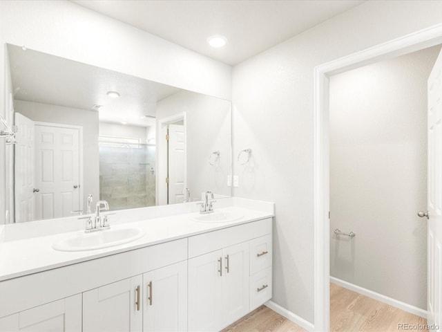 bathroom with vanity, a shower with door, and hardwood / wood-style floors