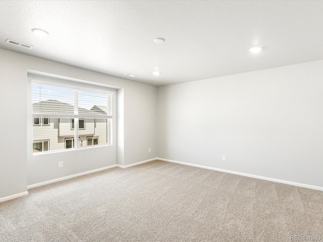 unfurnished room featuring carpet