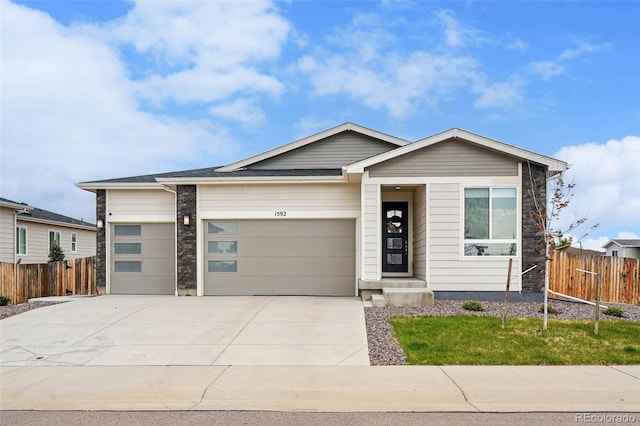1592 Maggie Mae Ln, Castle Rock, CO 80104 - view of front of home featuring fence, an attached garage, and concrete driveway