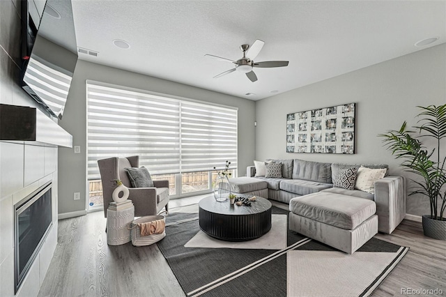1592 Maggie Mae Ln, Castle Rock, CO 80104 - living area with wood finished floors, ceiling fan, a fireplace, and baseboards