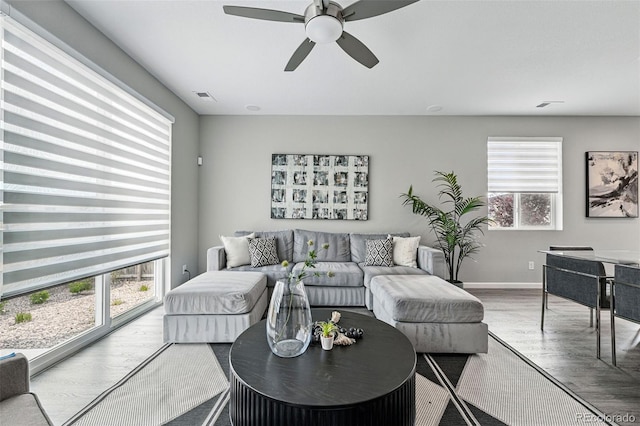 1592 Maggie Mae Ln, Castle Rock, CO 80104 - living area featuring wood finished floors, a ceiling fan, and baseboards