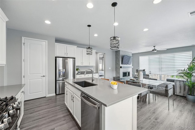 1592 Maggie Mae Ln, Castle Rock, CO 80104 - kitchen with a sink, stainless steel appliances, open floor plan, ceiling fan, and recessed lighting