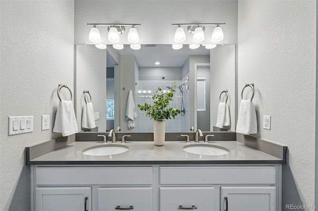 1592 Maggie Mae Ln, Castle Rock, CO 80104 - full bathroom with a stall shower, a textured wall, and double vanity