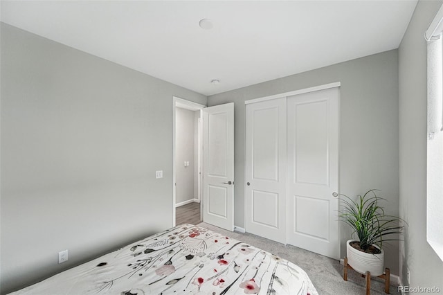 1592 Maggie Mae Ln, Castle Rock, CO 80104 - bedroom with light colored carpet, a closet, and baseboards