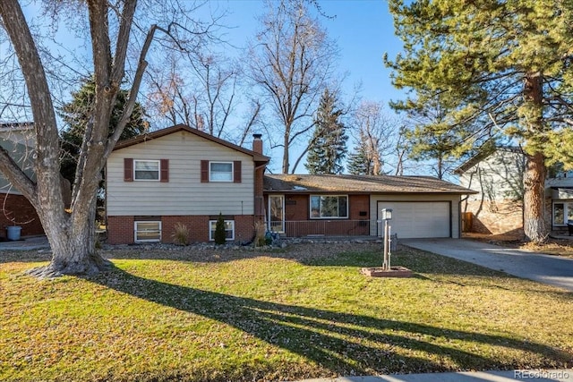 split level home with a garage and a front lawn