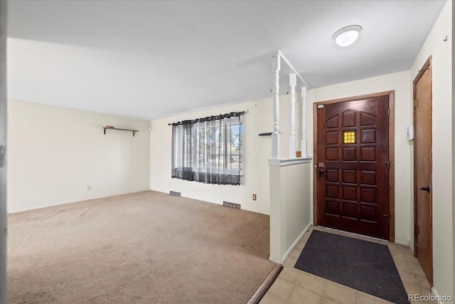 foyer entrance with light carpet