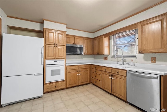 kitchen with sink, stainless steel appliances, and ornamental molding