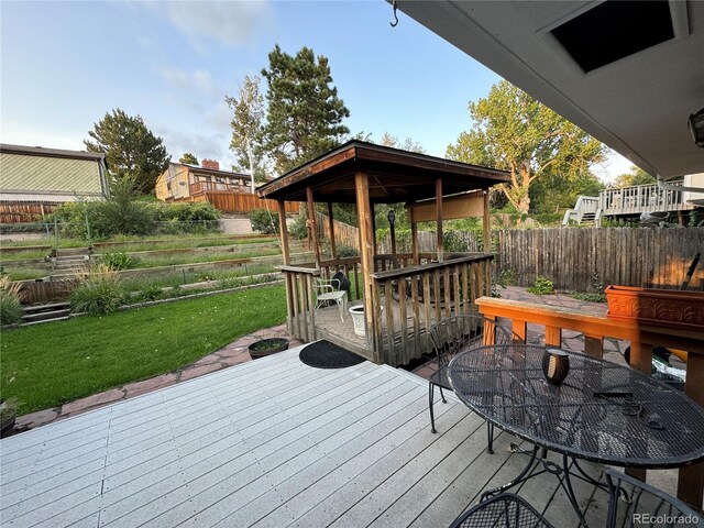 wooden terrace with a yard