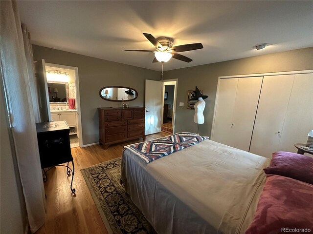 bedroom featuring light hardwood / wood-style flooring, ceiling fan, a closet, and ensuite bathroom