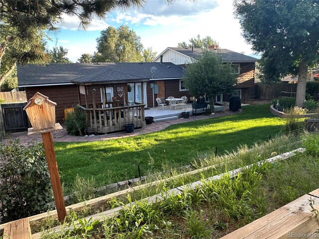 rear view of property featuring a yard and a patio