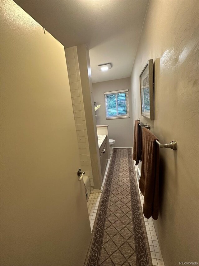 bathroom featuring vanity, toilet, and tile patterned flooring