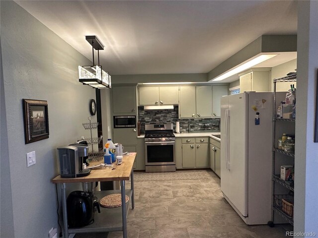 kitchen with pendant lighting, backsplash, and appliances with stainless steel finishes