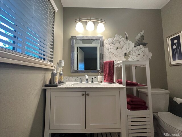 bathroom with vanity and toilet