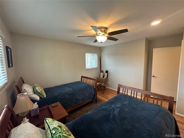 bedroom with ceiling fan and hardwood / wood-style floors