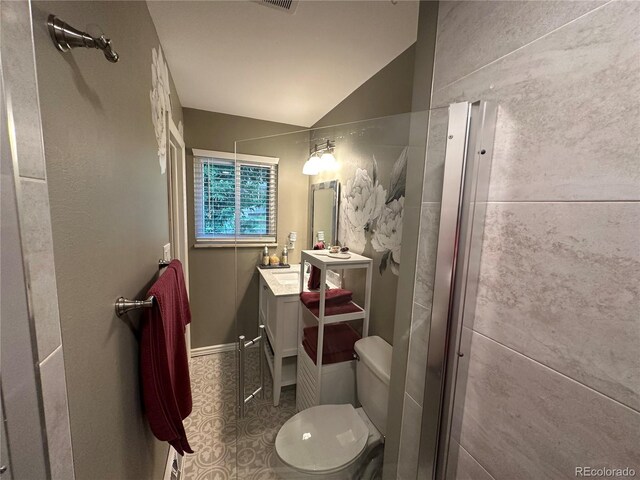 bathroom featuring vaulted ceiling, toilet, and vanity